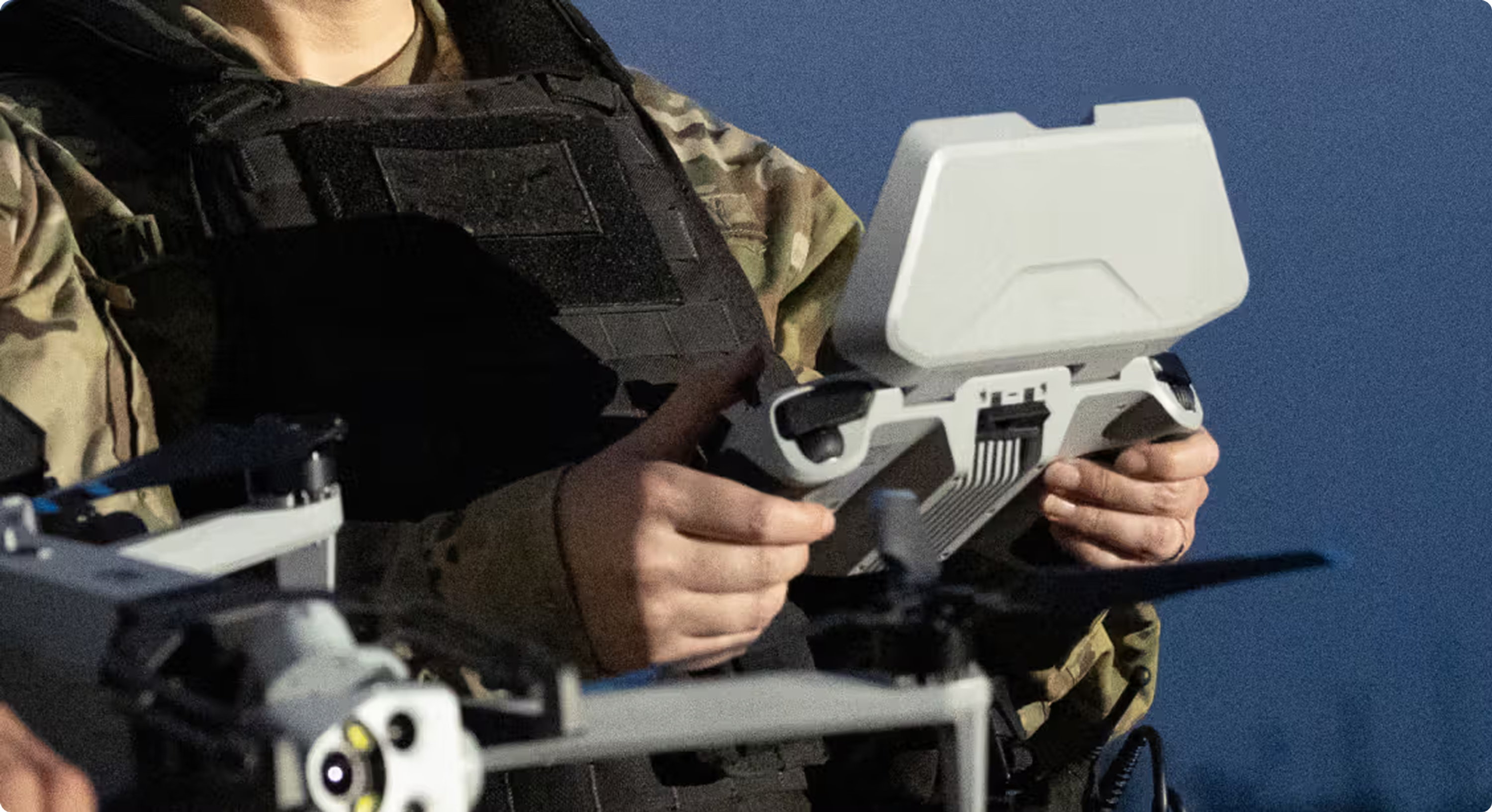 soldier's hands holding Skydio X10D controller with Skydio X10D drone in the foreground