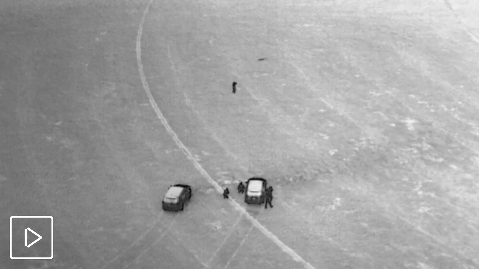 Skydio X10 drone thermal image of two police vehicles, officers and subject