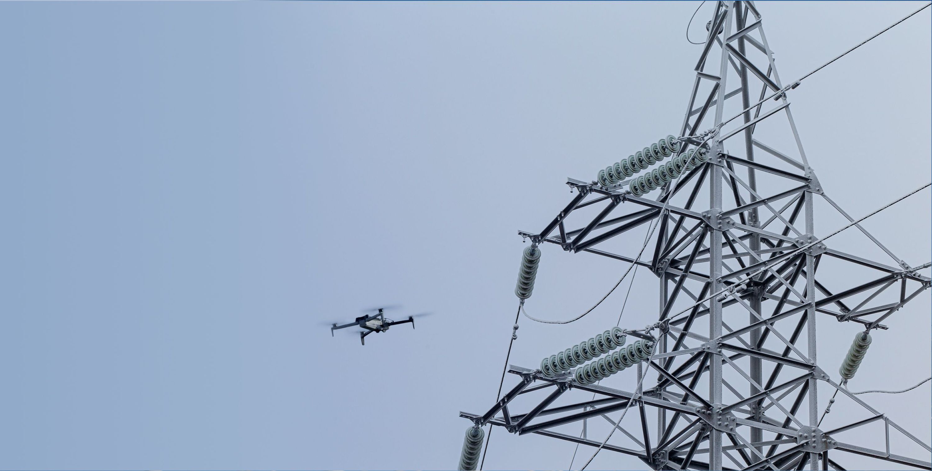 Skydio X10 drone flying over power lines