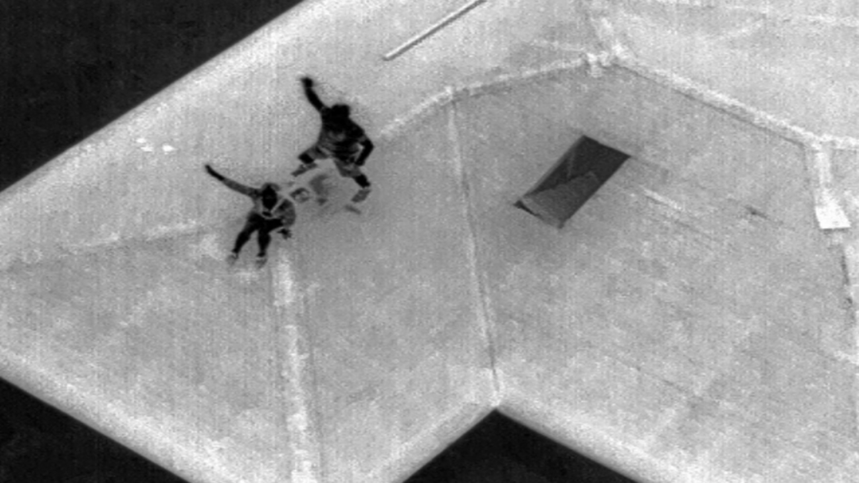 thermal image of two people on a rooftop captured with Skydio drone