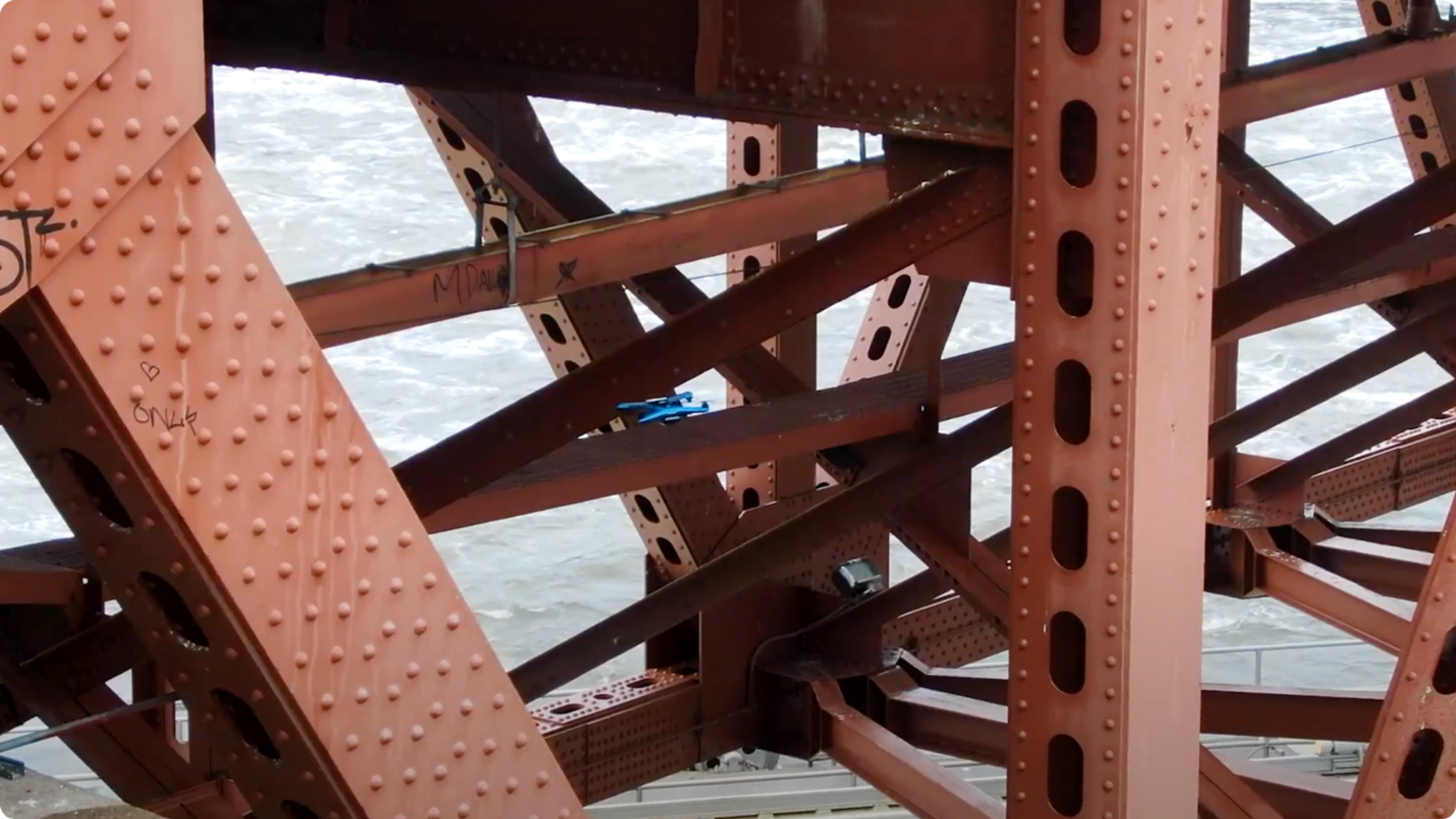 Skydio inspection drone flying near steel bridge structure
