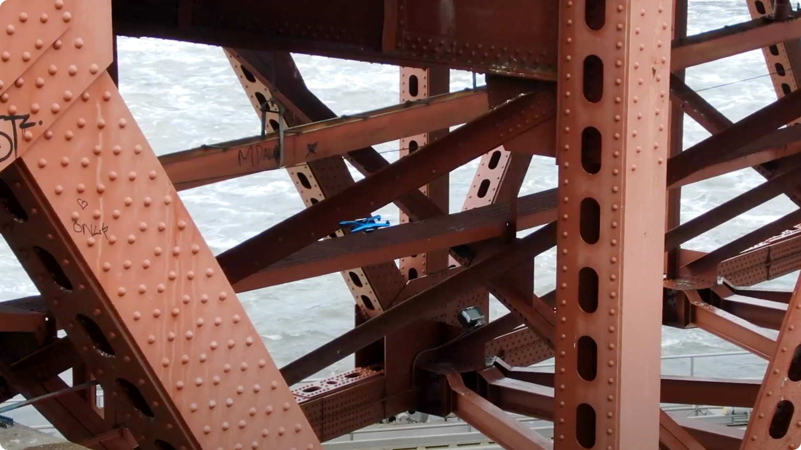Skydio inspection drone flying near steel bridge structure