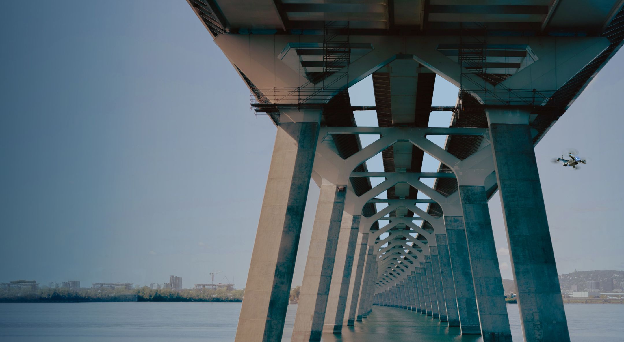 Skydio drone flying a bridge inspection under a cement bridge structure