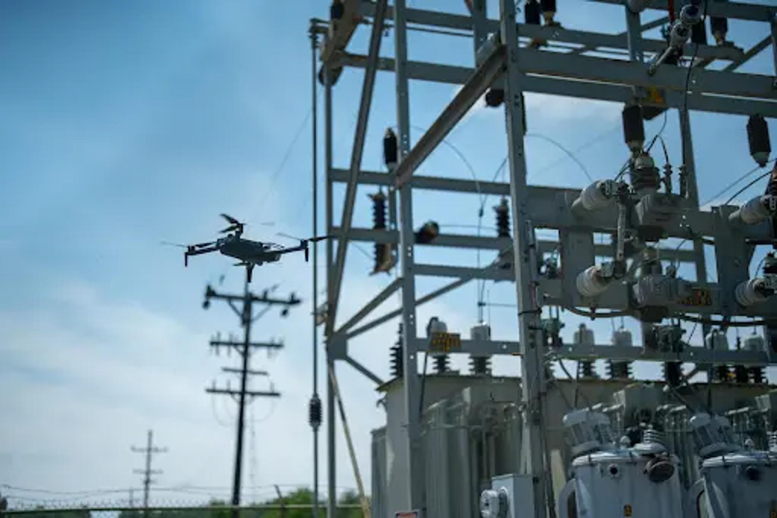 Skydio inspection drone flying near a power transformer