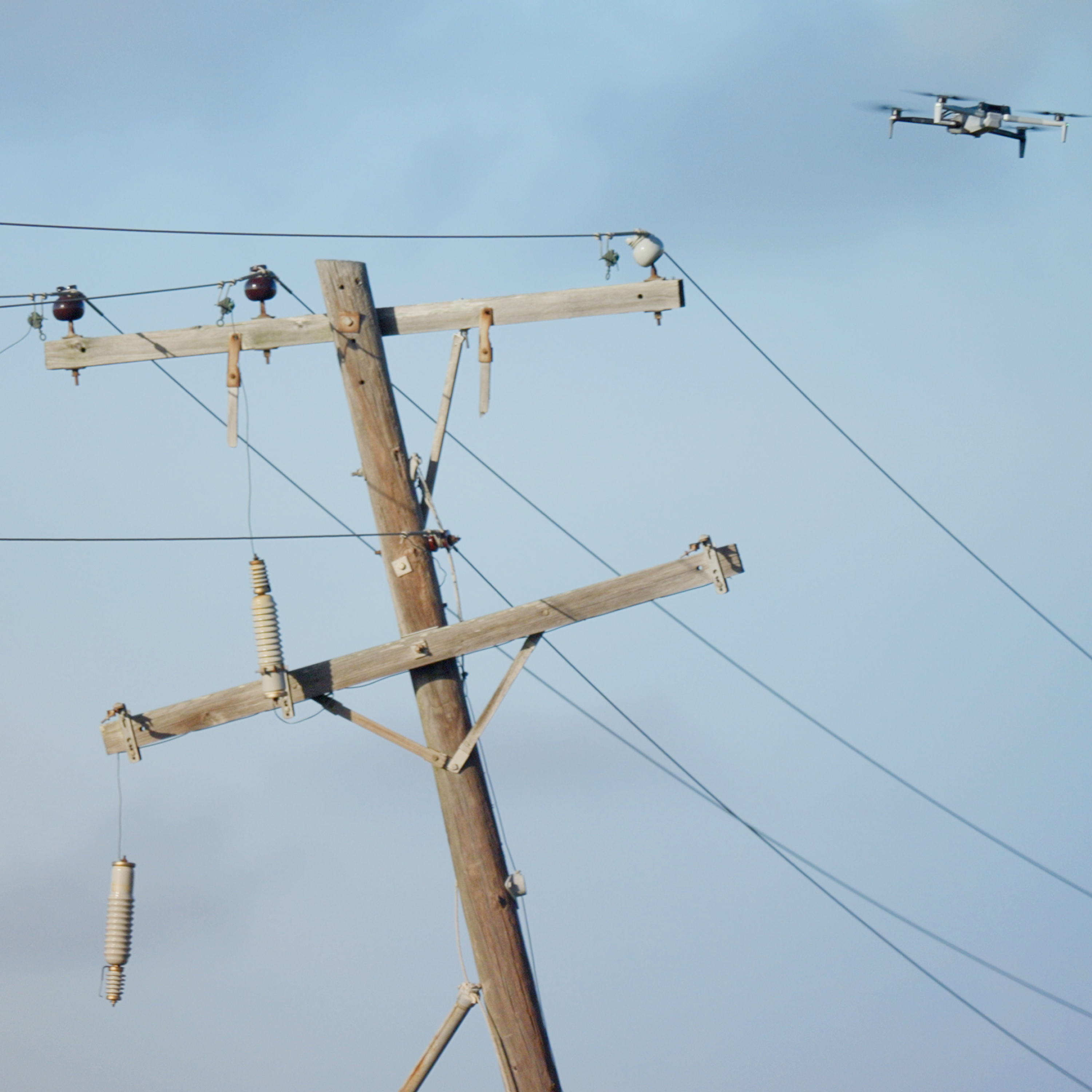Aerial view of a road with power lines running along them