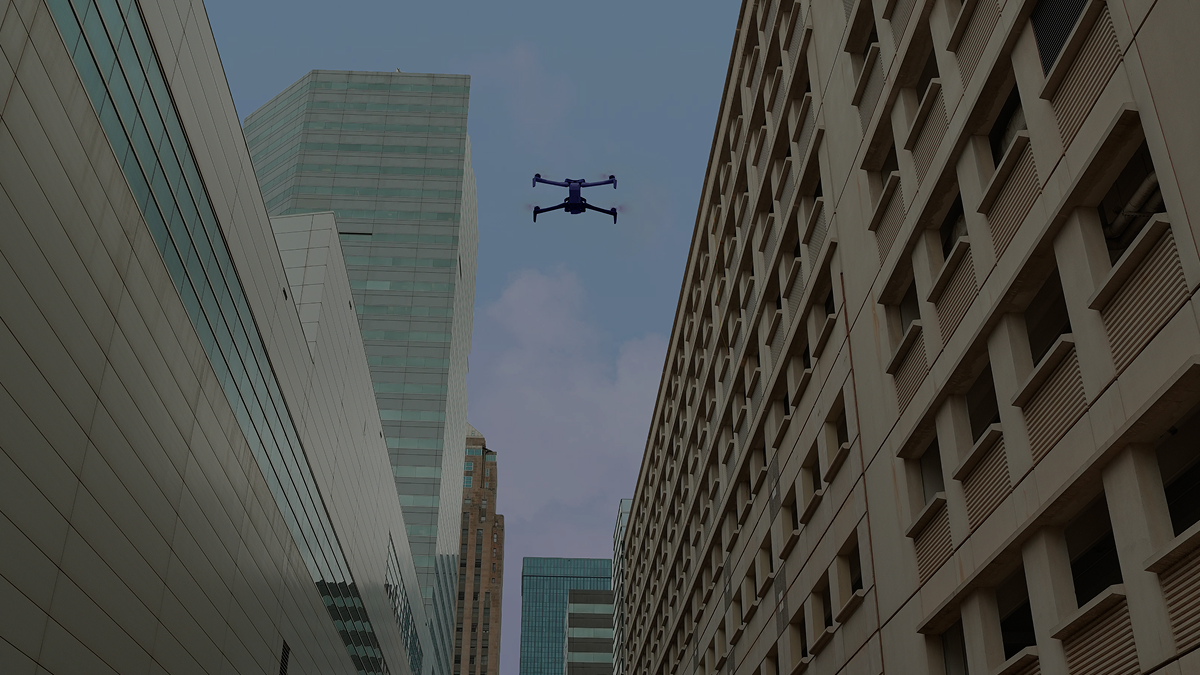 Skydio X10 drone flying in an urban canyon