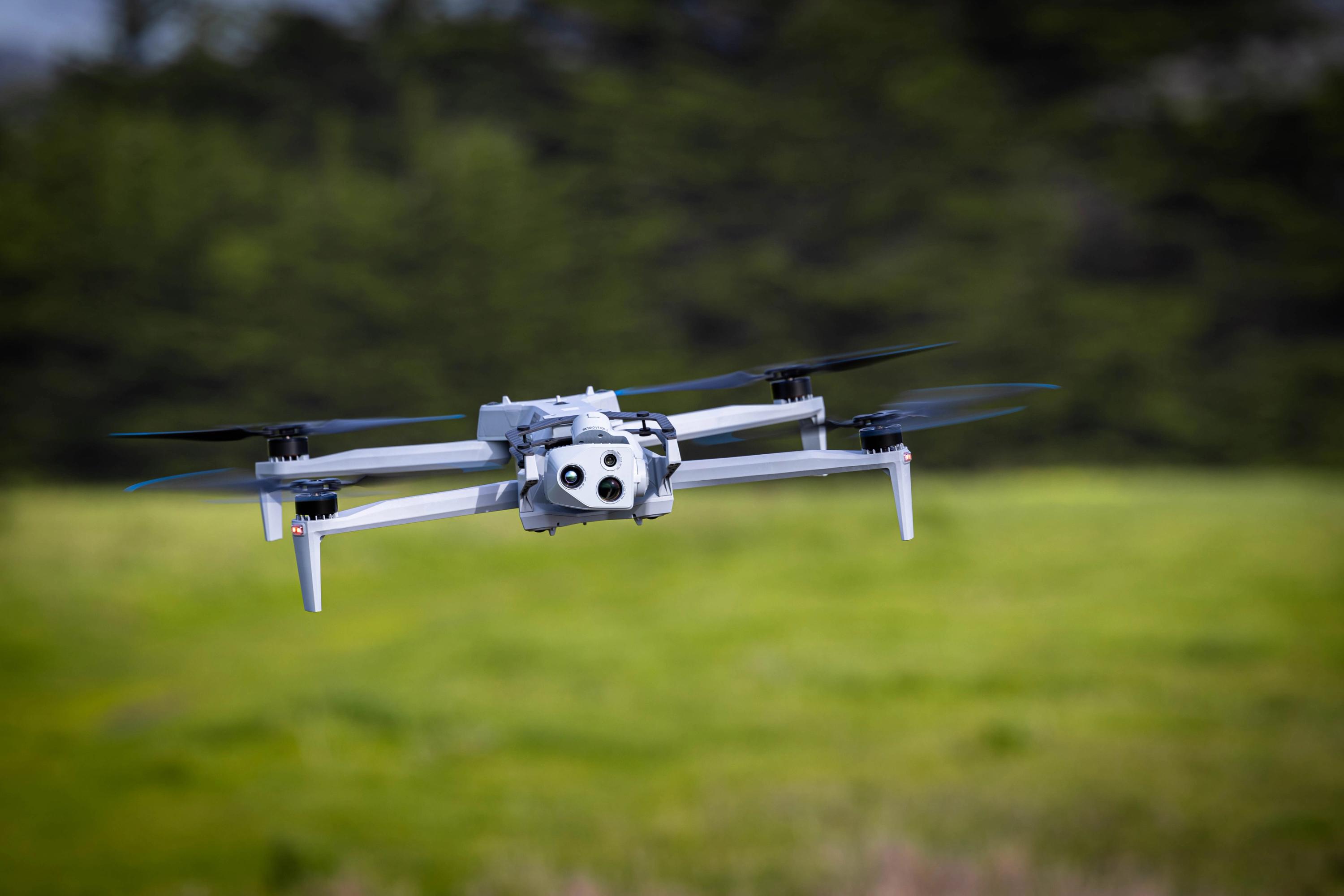 Skydio X10 in flight in forested area 