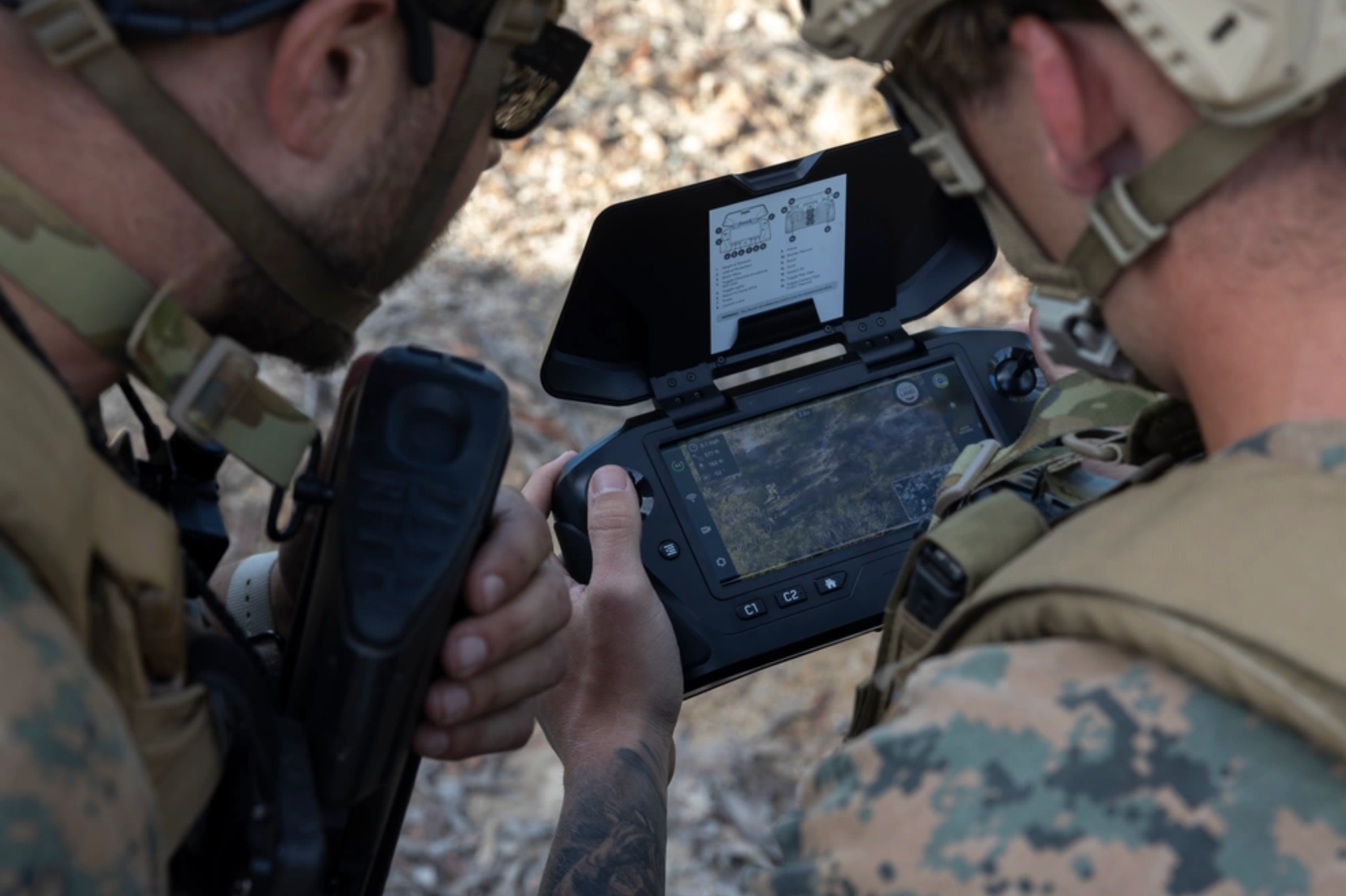 Warfighters holding controller, flying Skydio drone