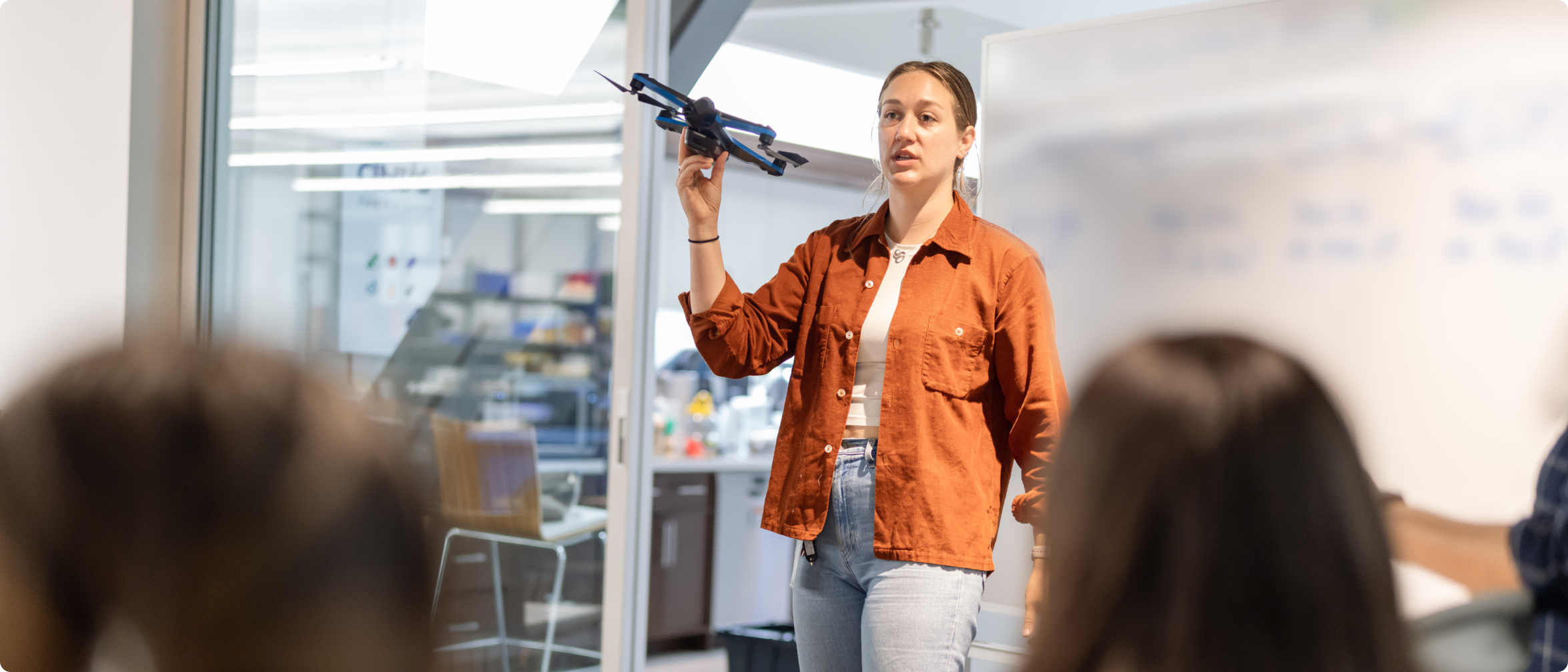 woman with Skydio drone in hand providing classroom training