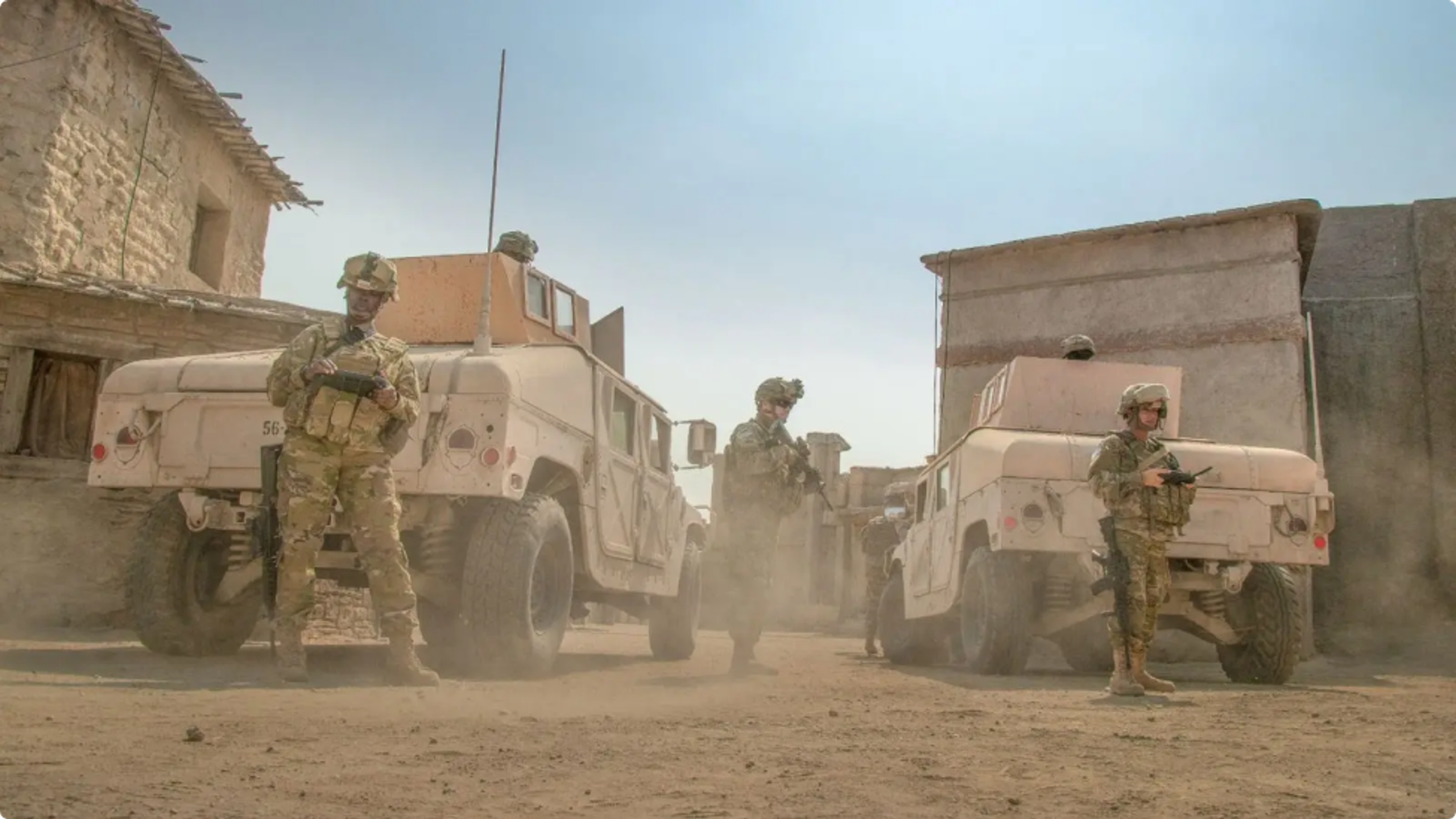 military vehicles and warfighters with Skydio drone controllers in hand