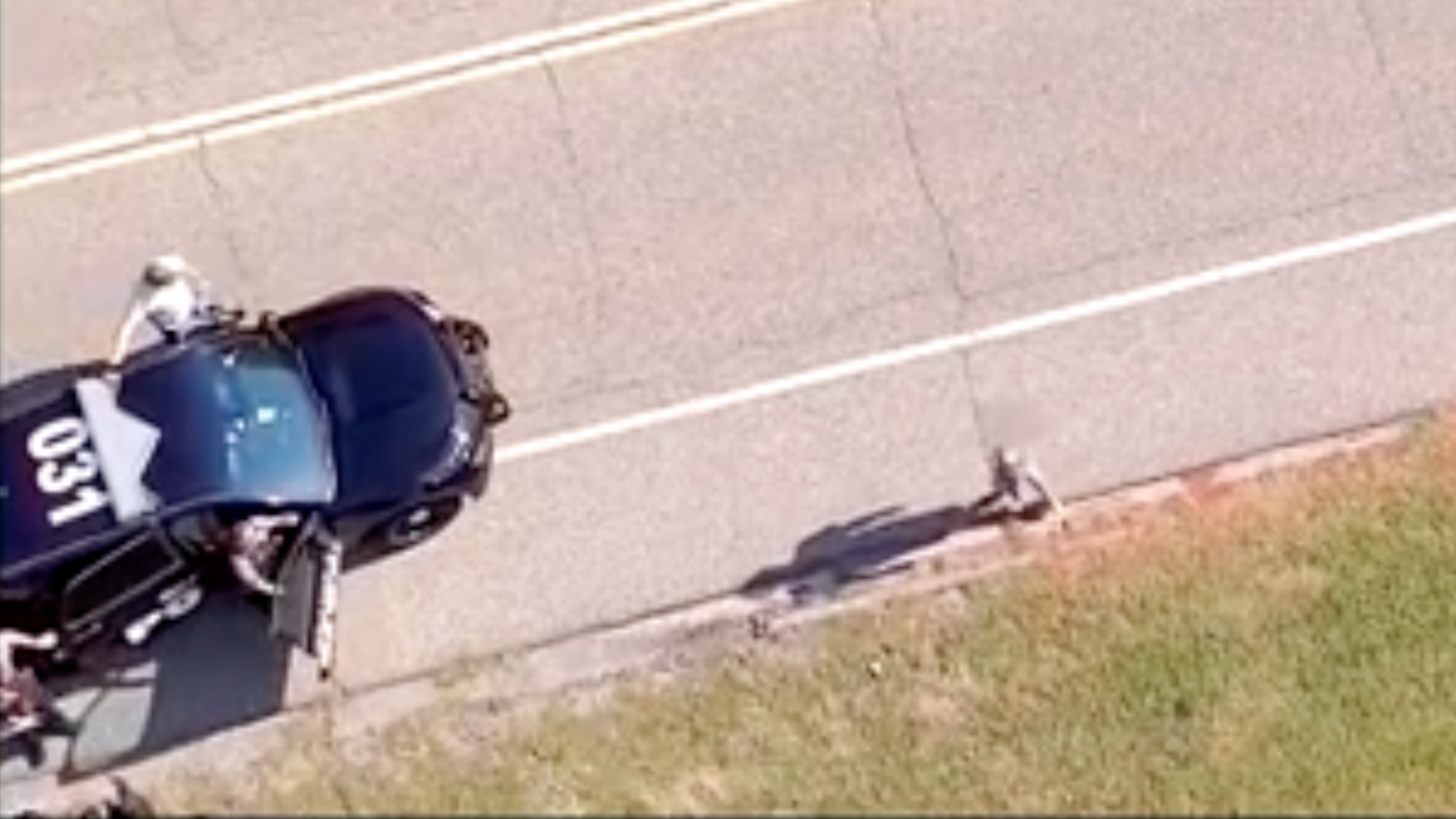 drone view of a police officer and car