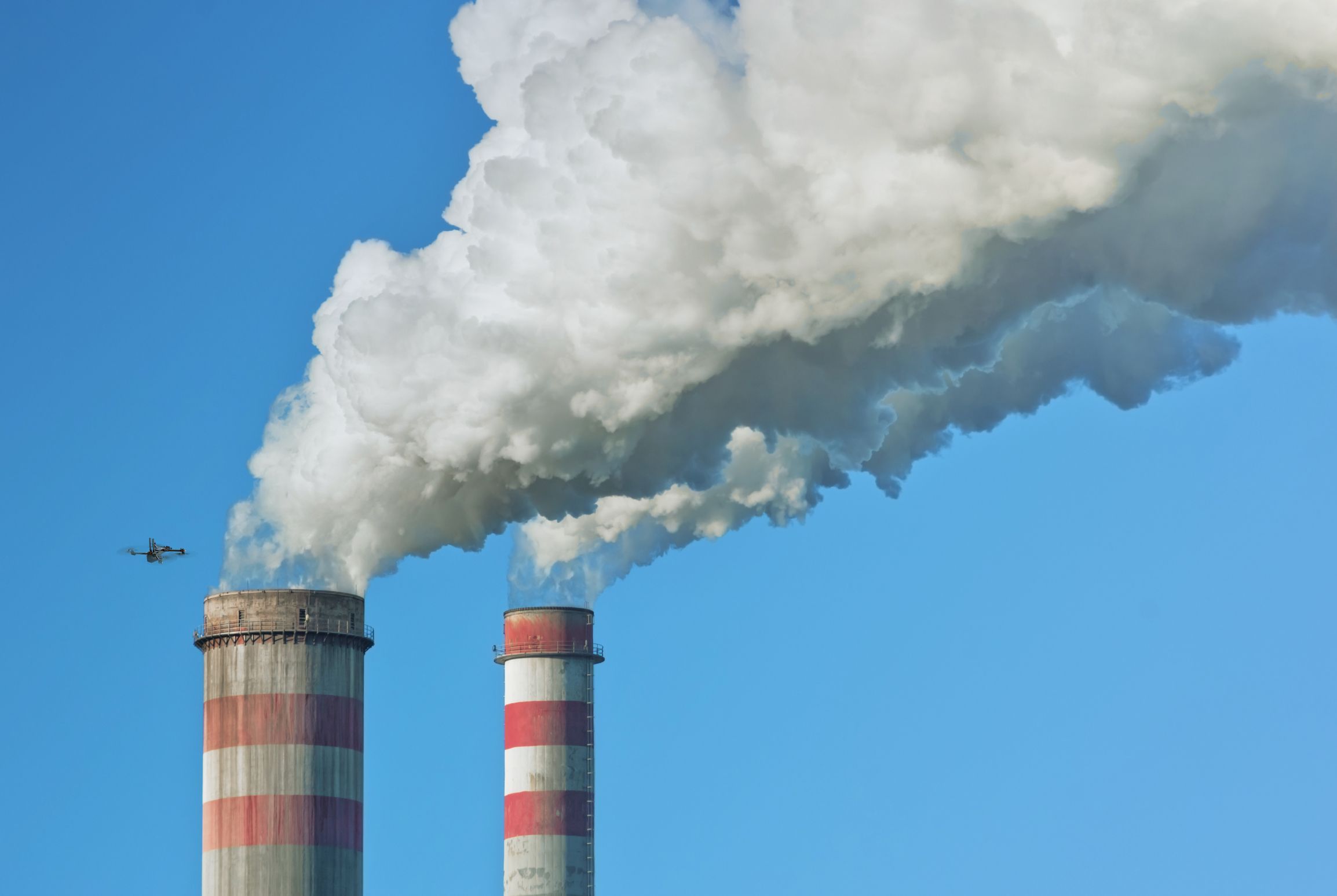 Skydio drone flying near smoke stacks
