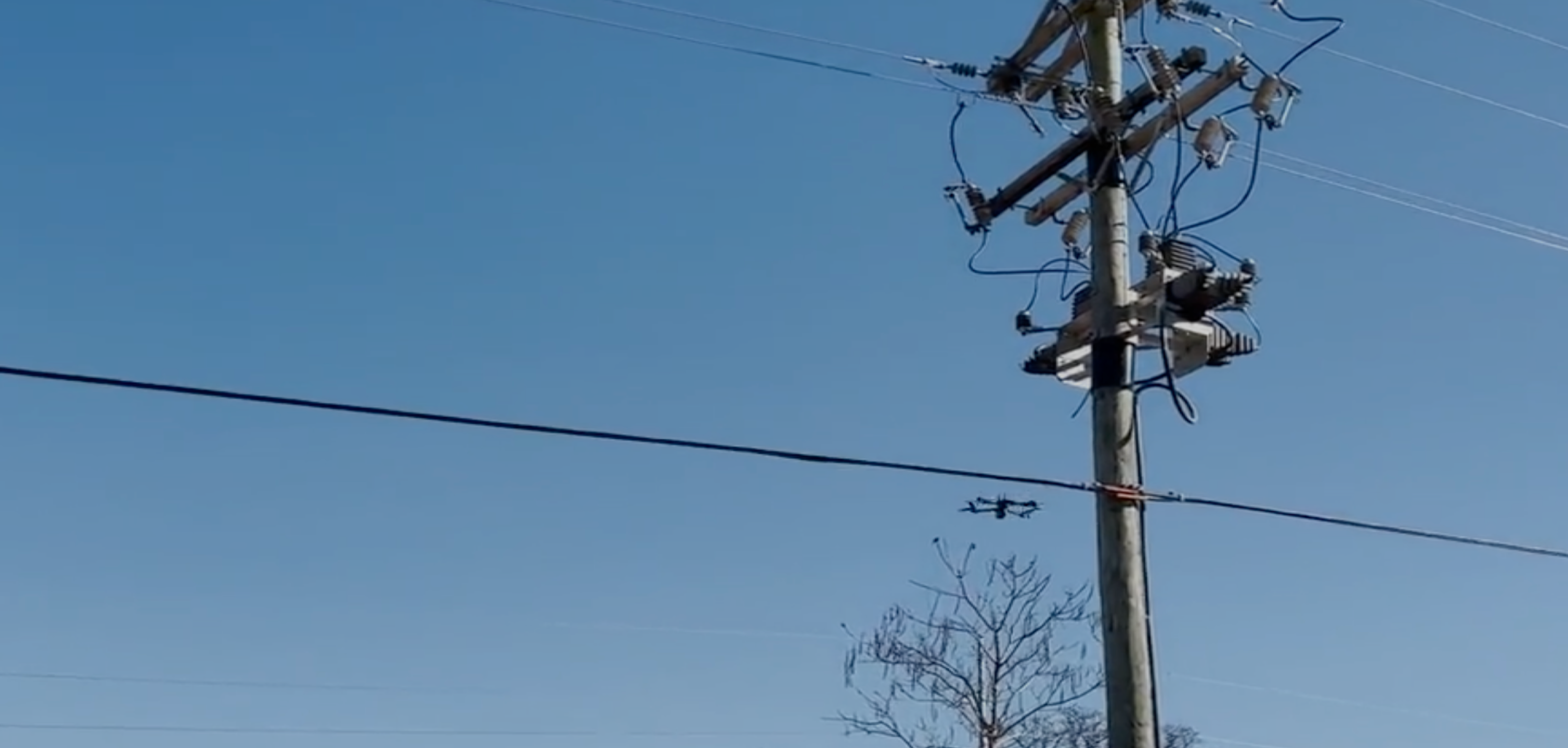 Skydio drone flying a utility inspection near power wires
