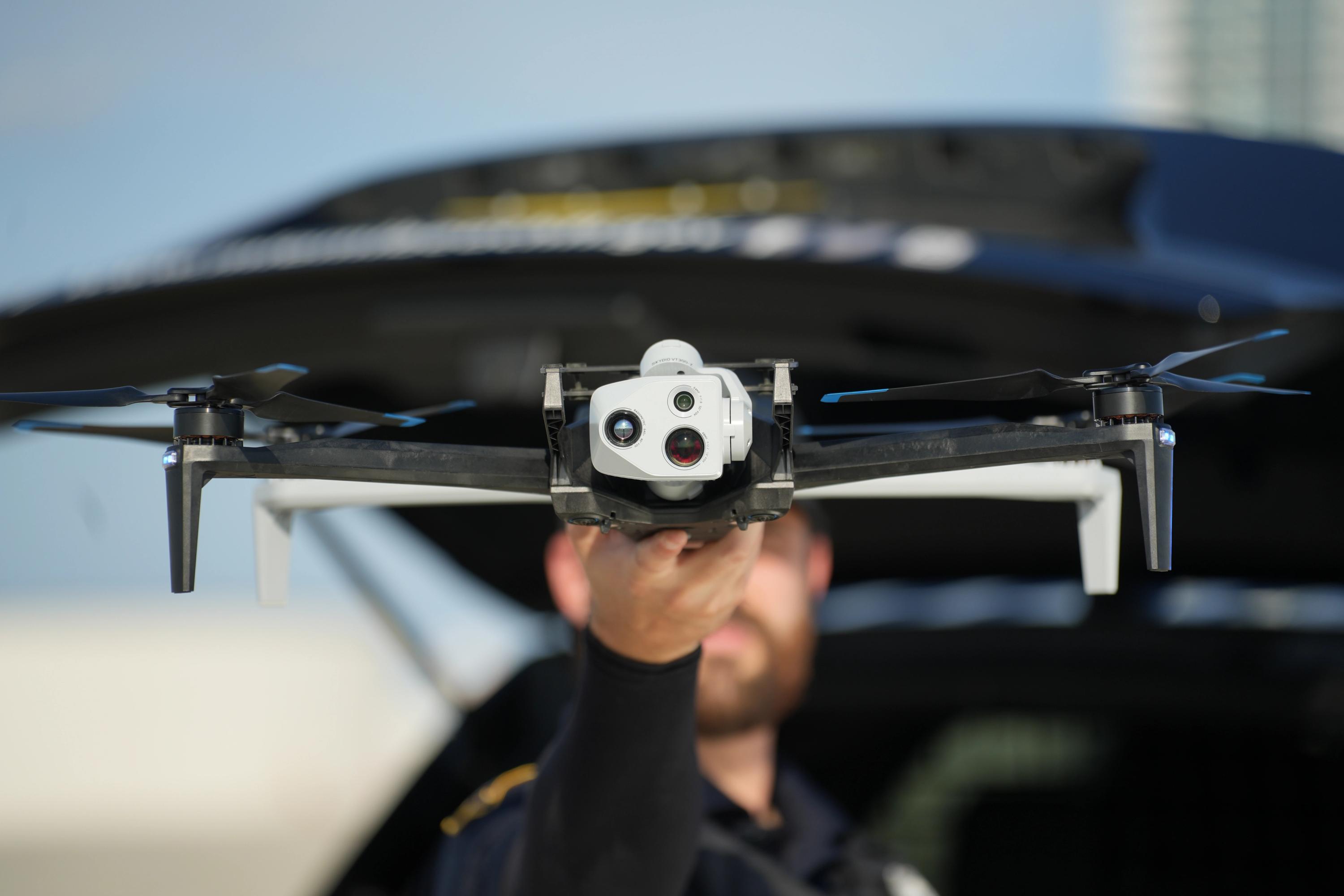 Officer launching Skydio X10  from patrol car in Miami Beach  