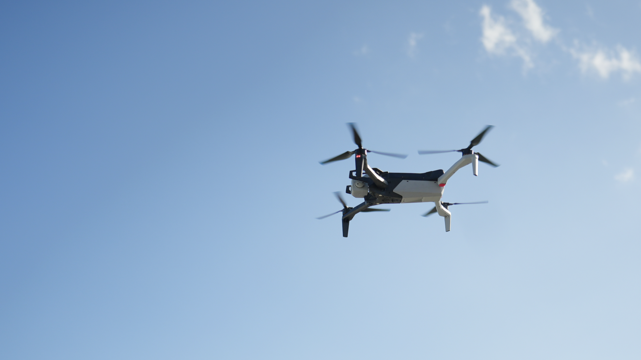 Skydio X10 in flight from the underside looking into the sky