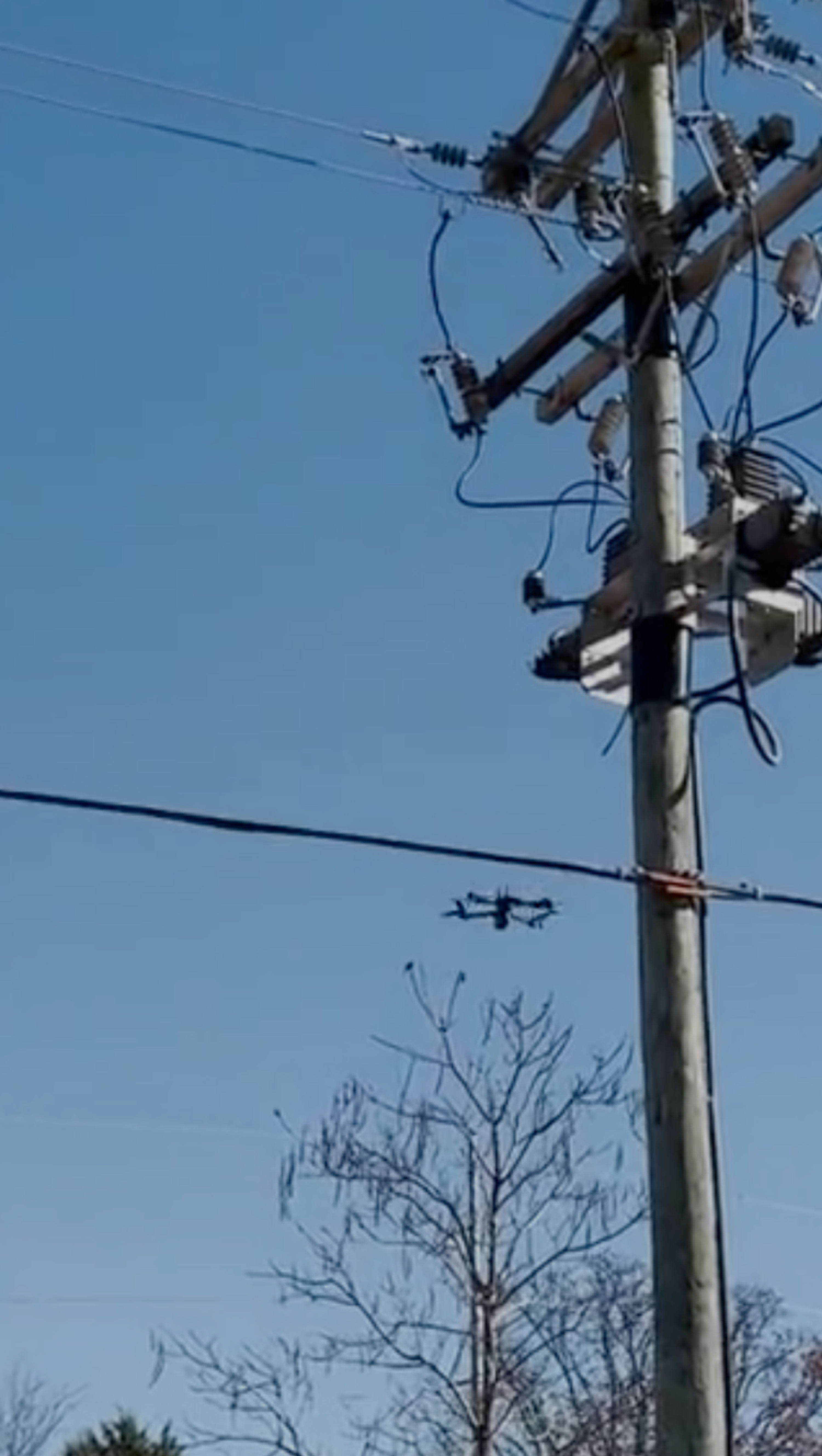 Skydio drone flying a utility inspection near power wires
