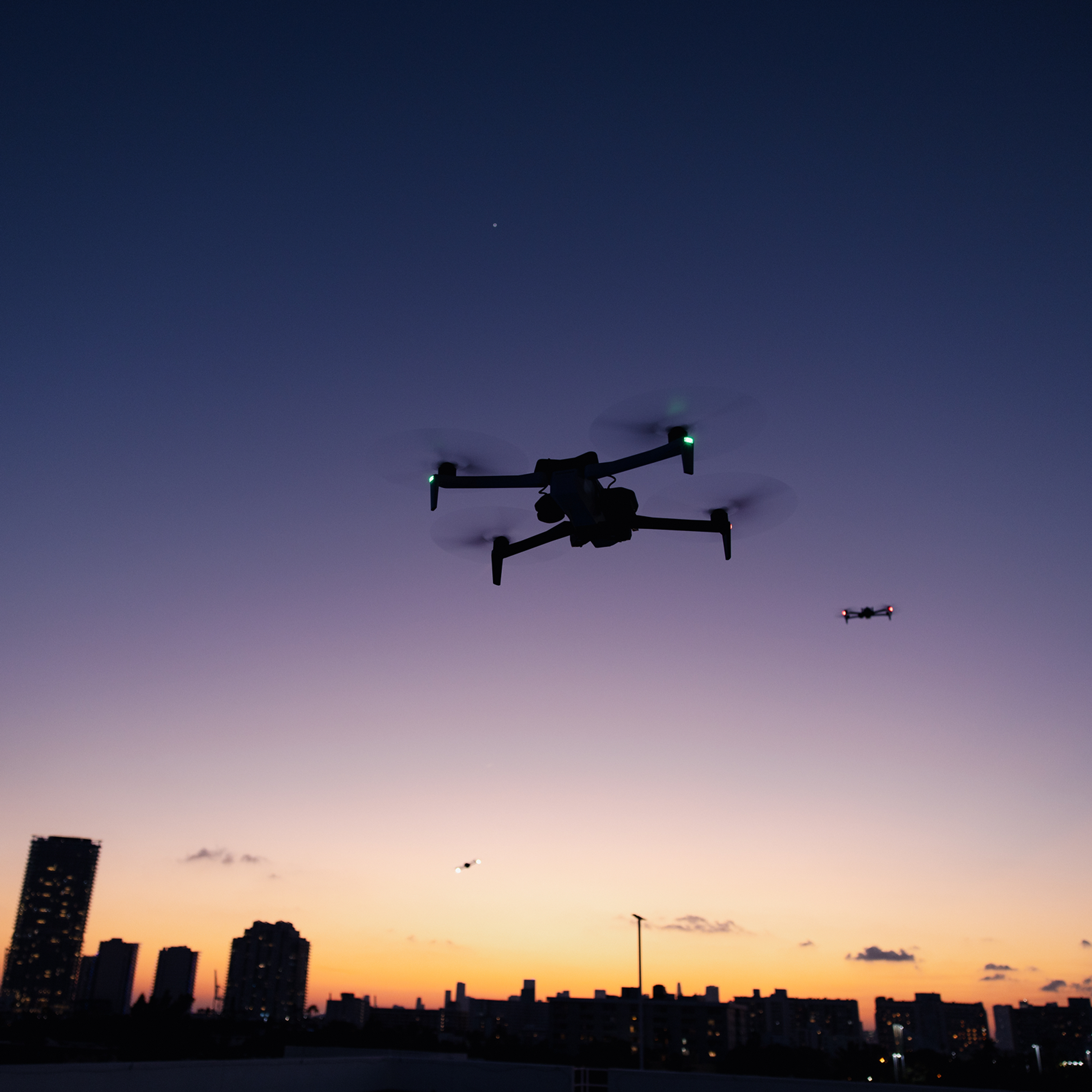 Two Skydio X10 drones fly over Miami Beach at sunset 