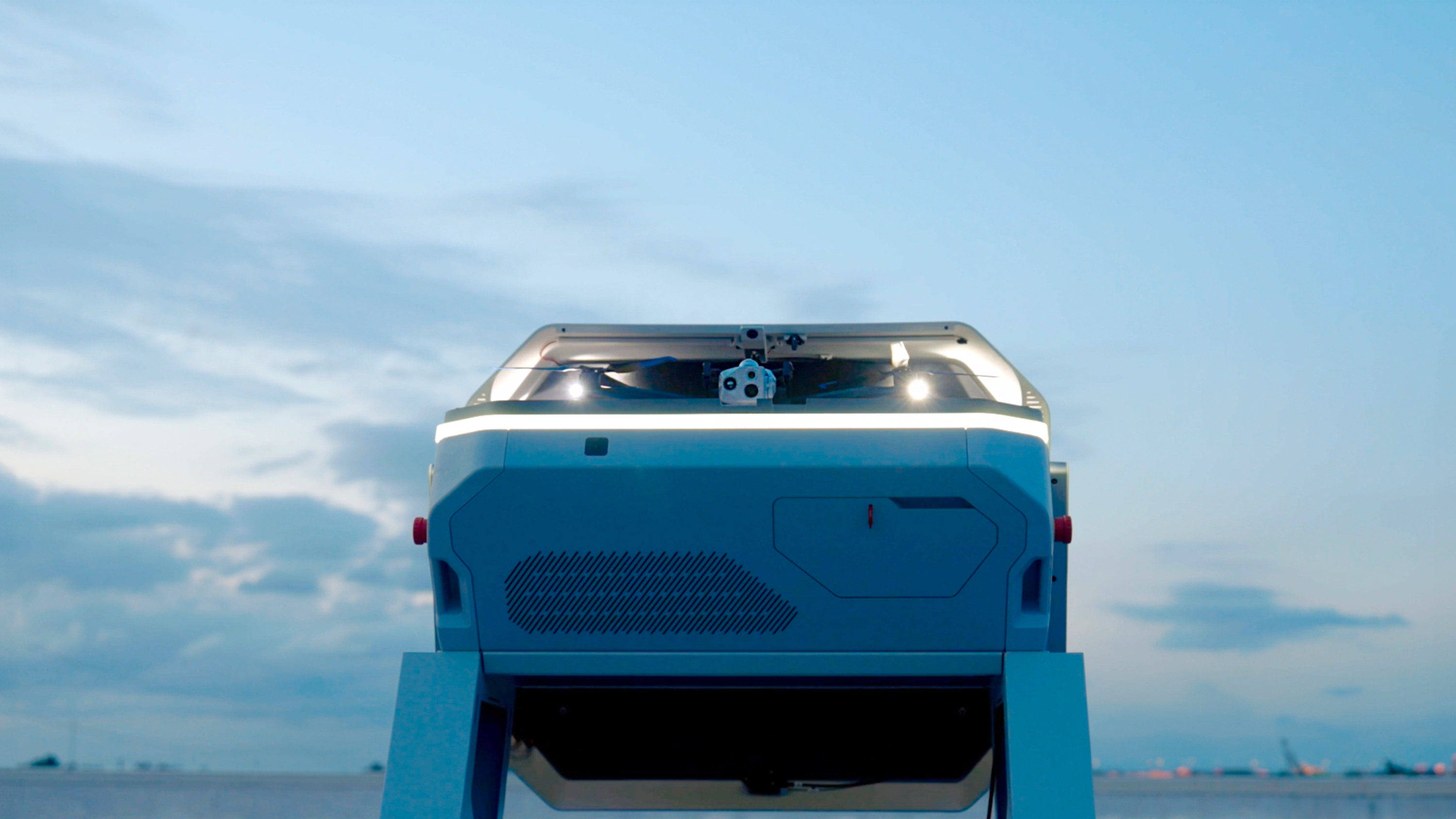 Skydio Dock for X10 with Skydio X10 drone inside, clouded sky in the background