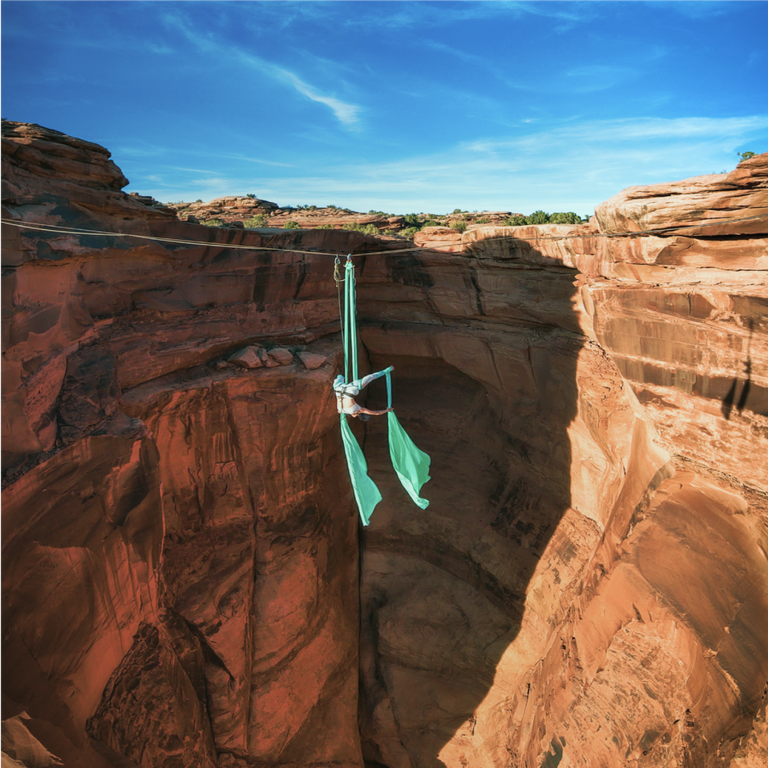 acrobat on wire over canyon