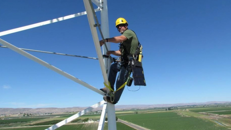 person climbing  transmission electricity tower