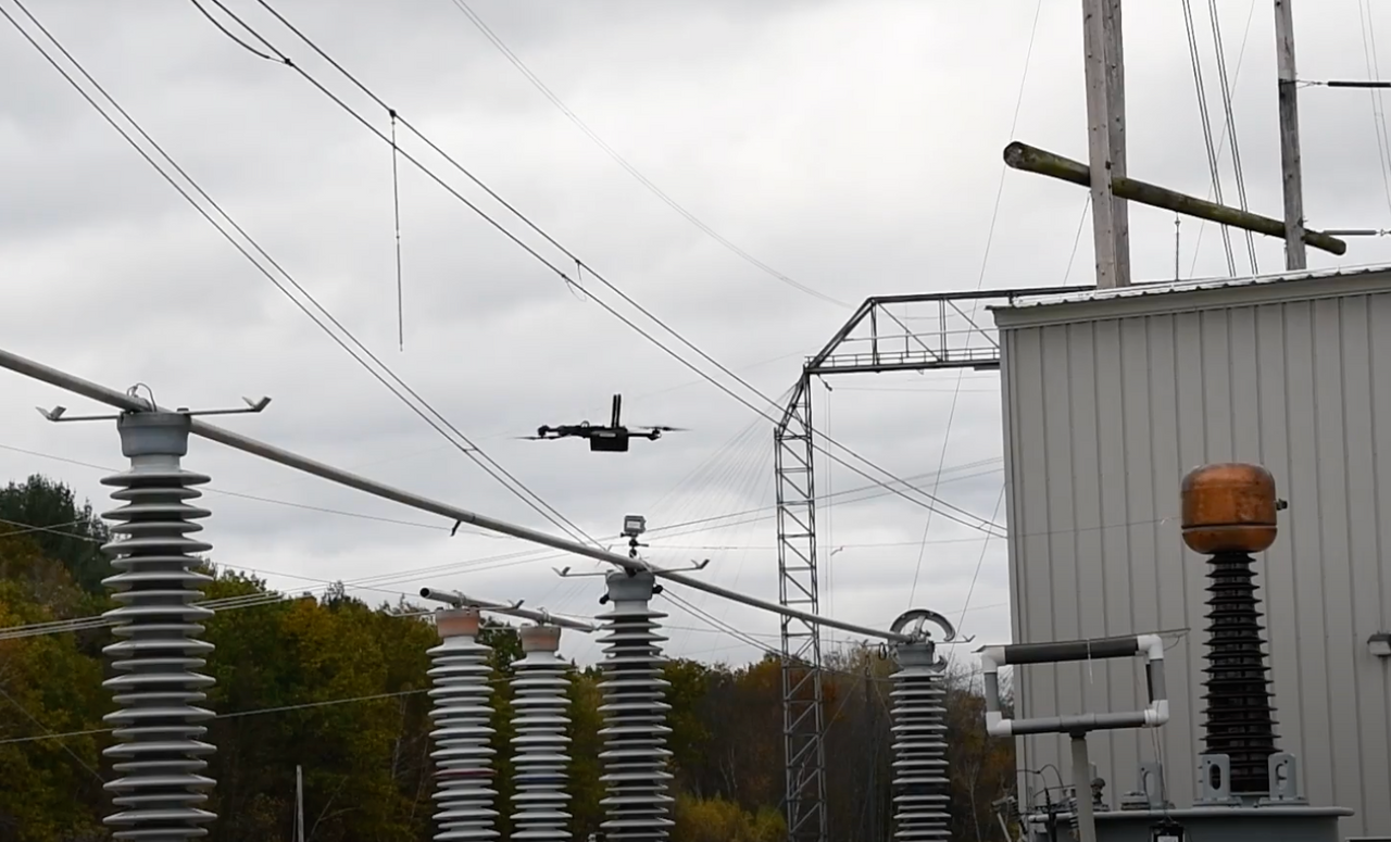 drone flying by power lines