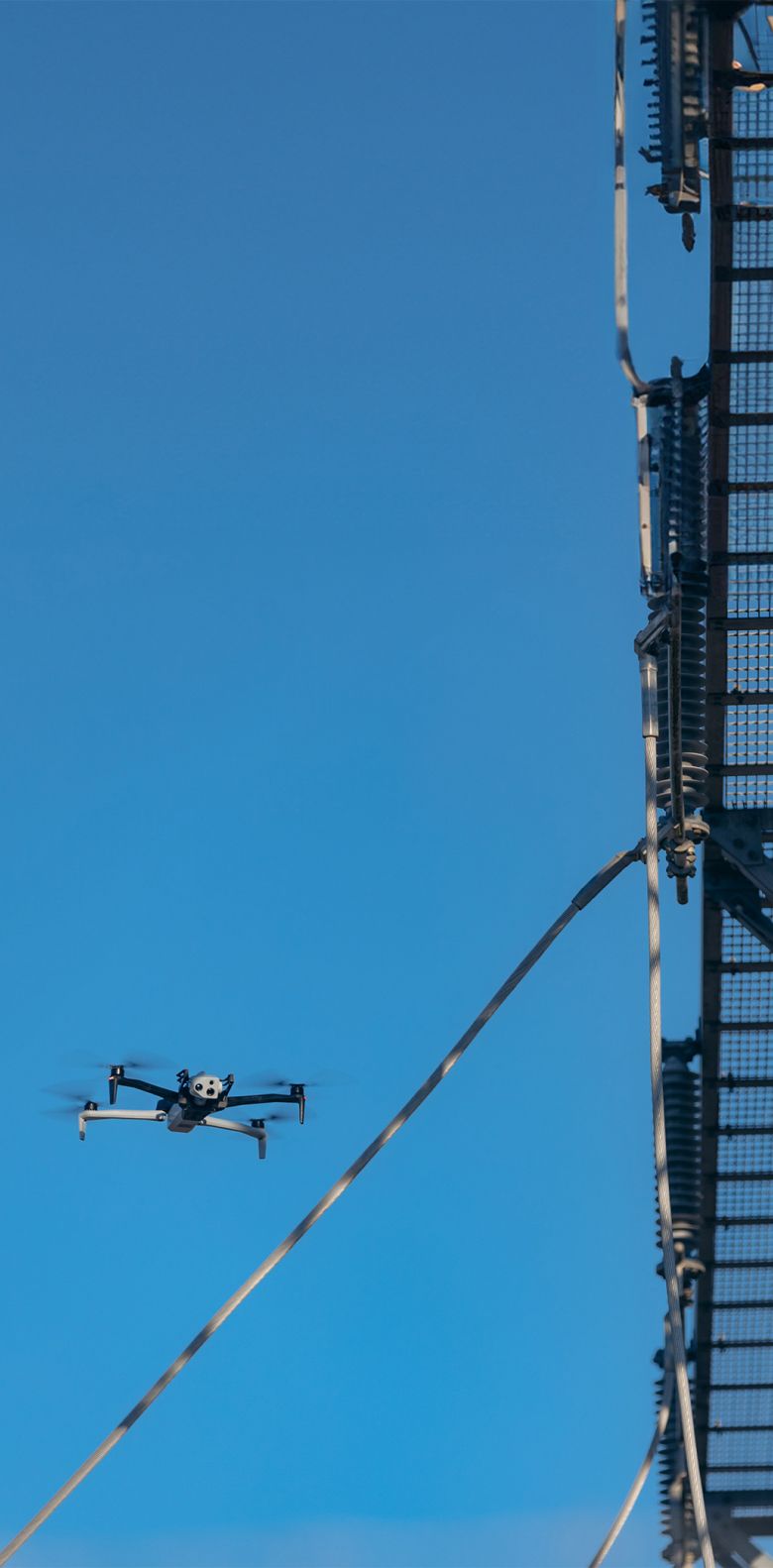 Narrow view of Skydio drone flying around a power line