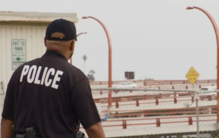 police looking out over an area ready to fly drone