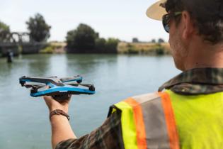 Skydio S2 Drone Holding In Hand Yellow Vest