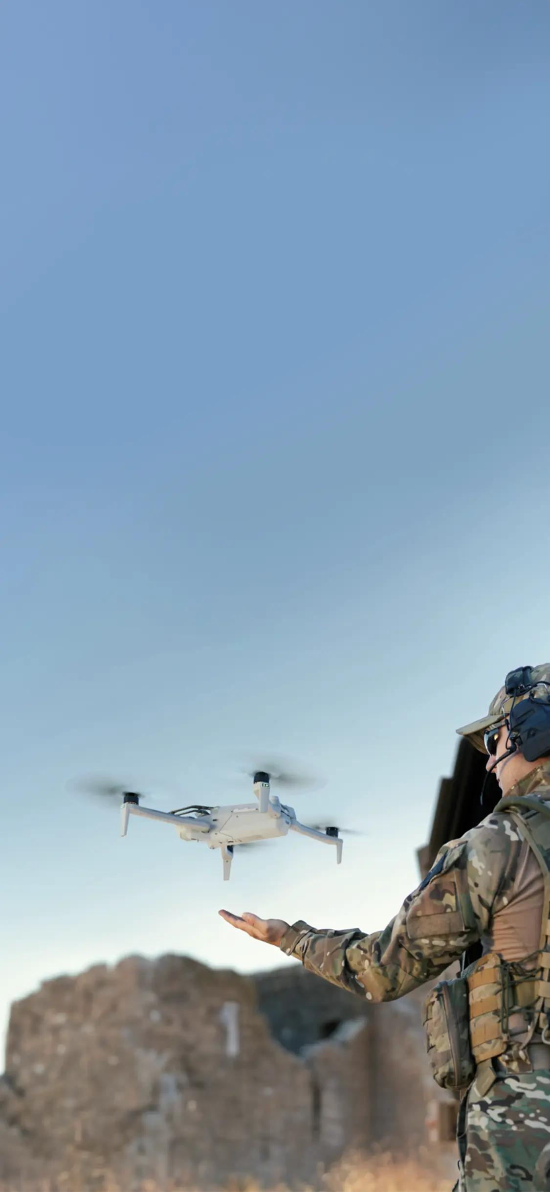 soldier releasing drone from hand