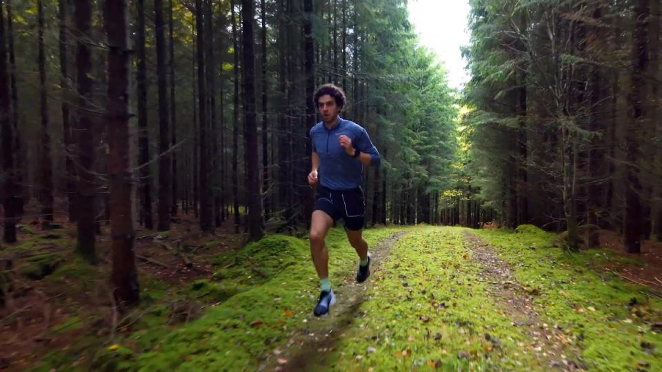 Skydio drone flying backwards in dense forest following Alexander Holmblad