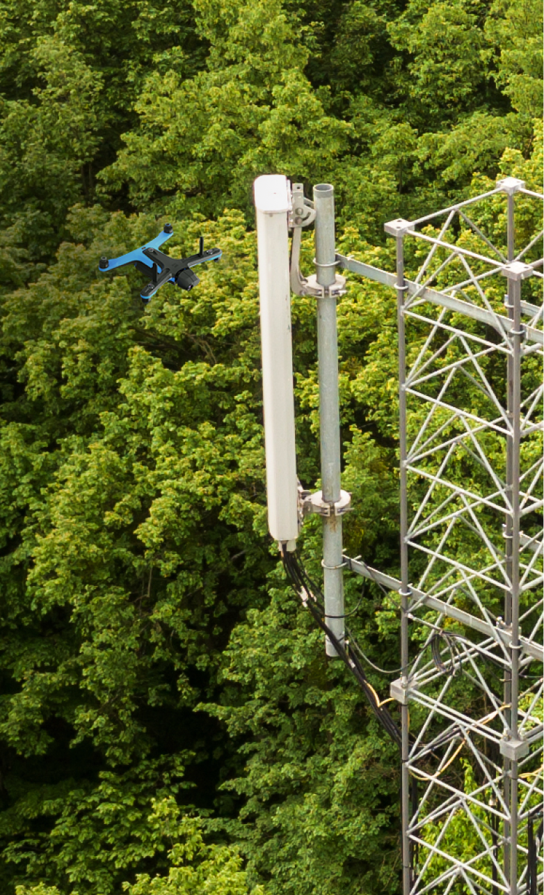 portrait view of Skydio drone in flight inspecting cell tower