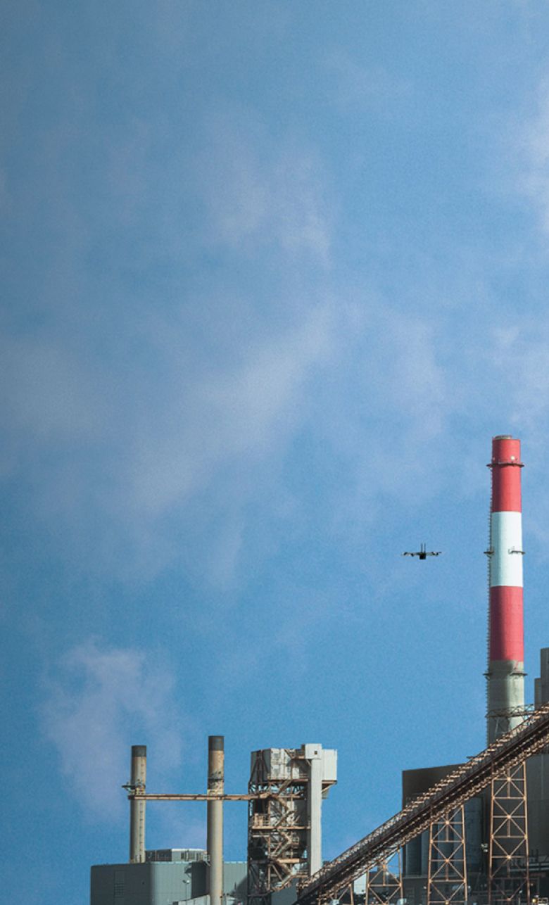 Narrow view of Skydio flying near a power plant facility