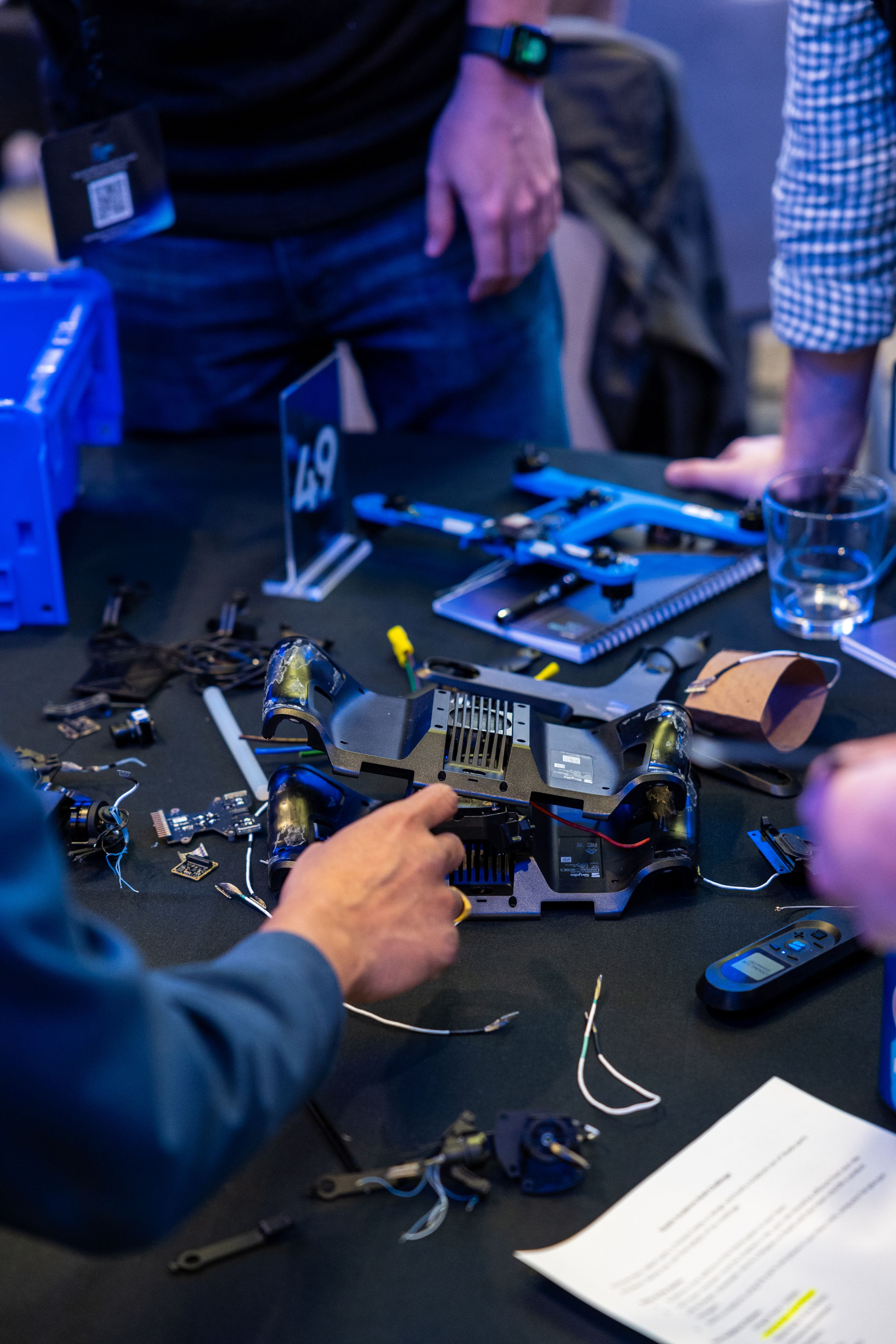 Tabletop with various electronics and Skydio drone parts.