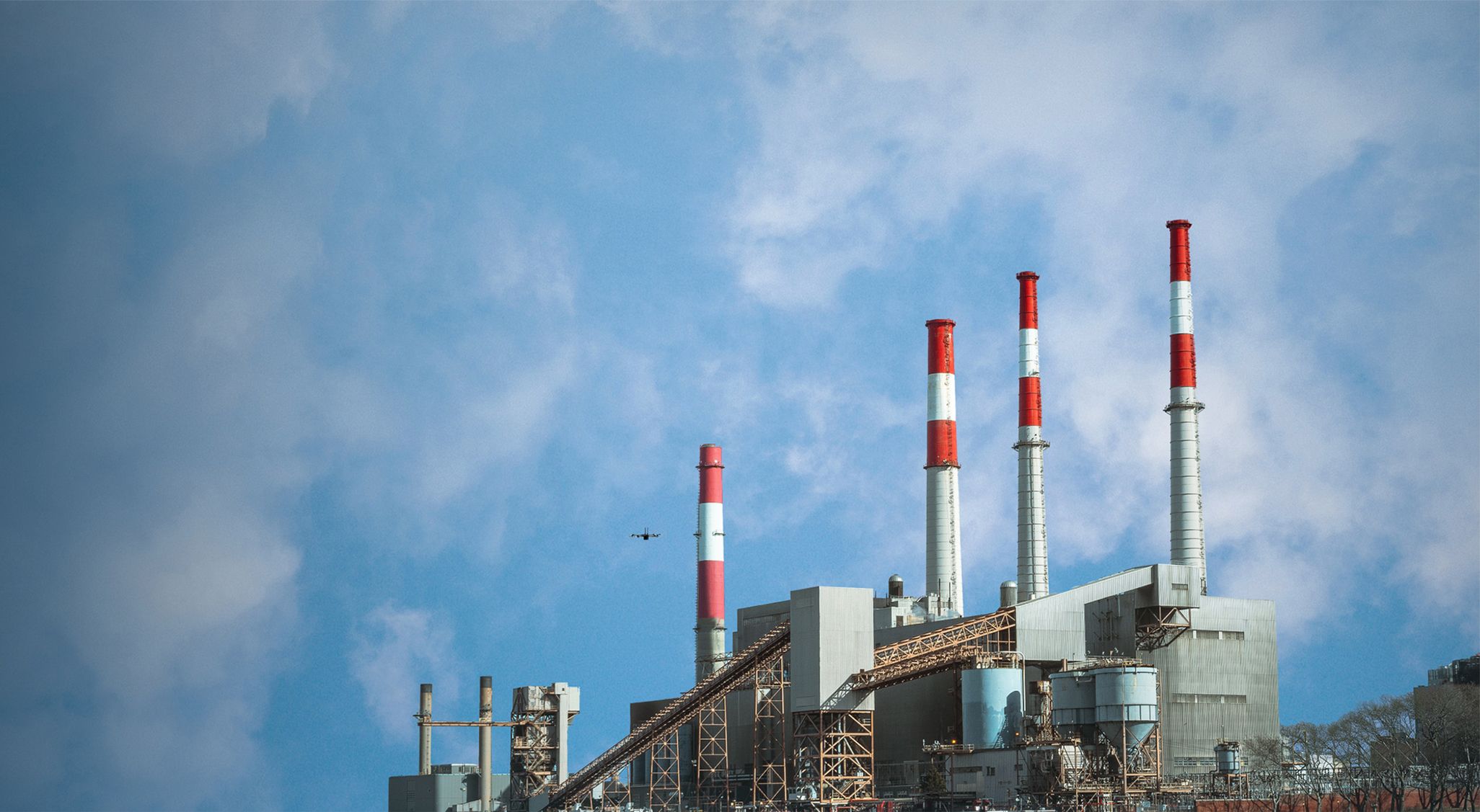 Wide view of Skydio flying near a power plant facility