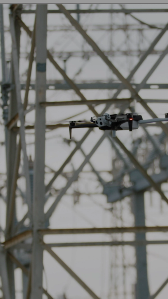 AEP worker using Skydio X10 to navigate and inspect large substation portrait orientation