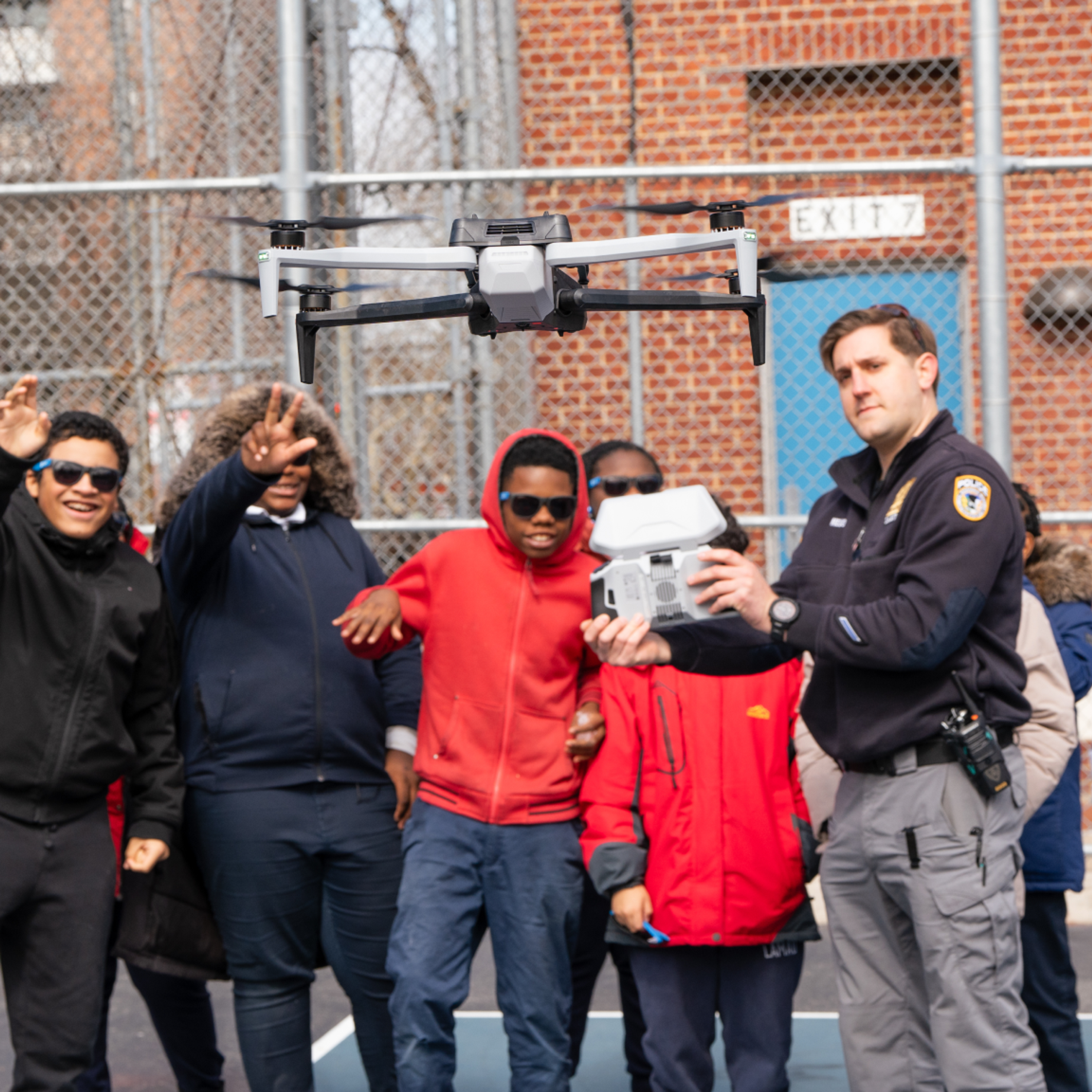 officer showing school age pupils the Skydio X10 drone