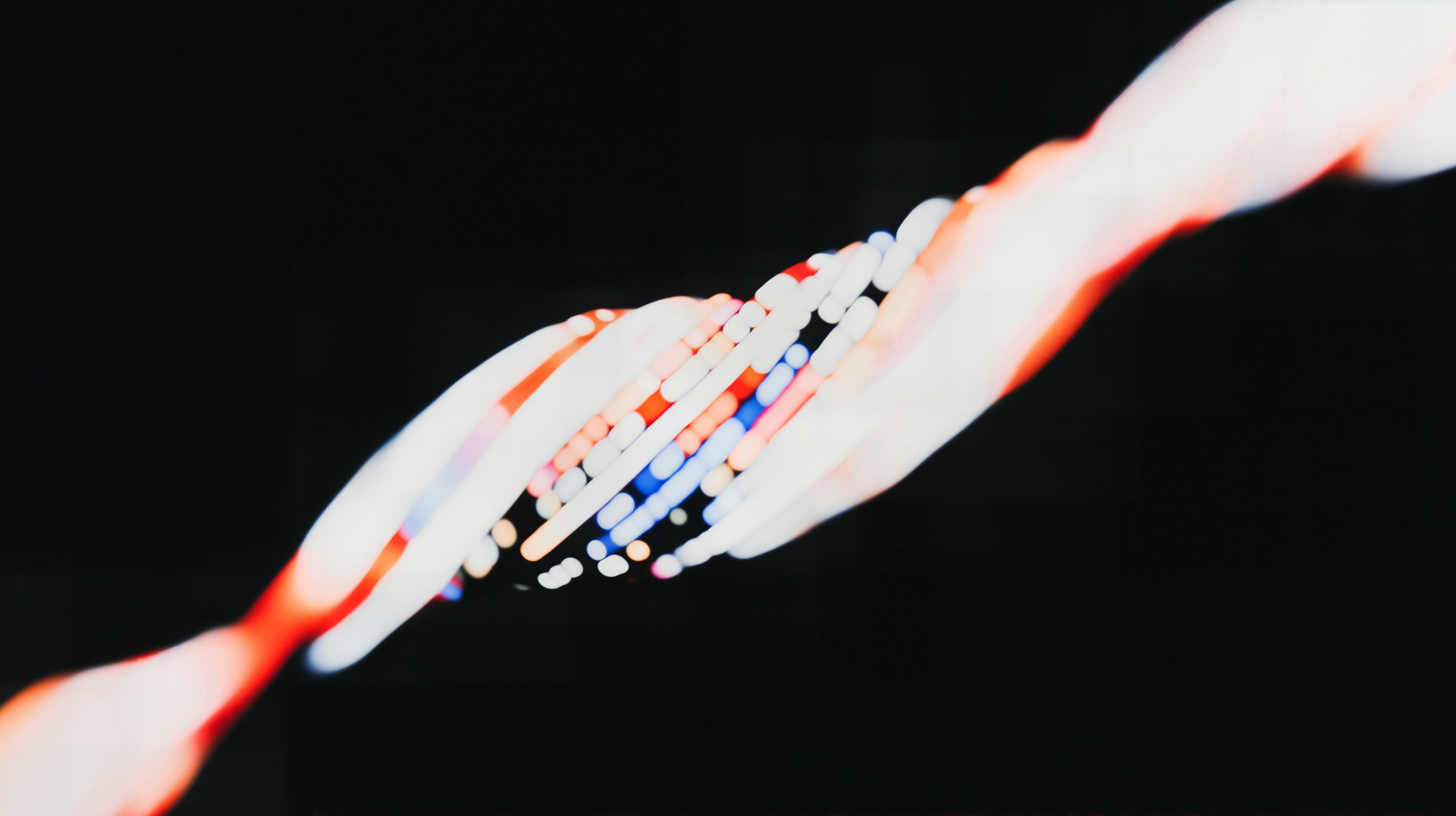 Abstract light trails in red, white, and blue, resembling a DNA helix