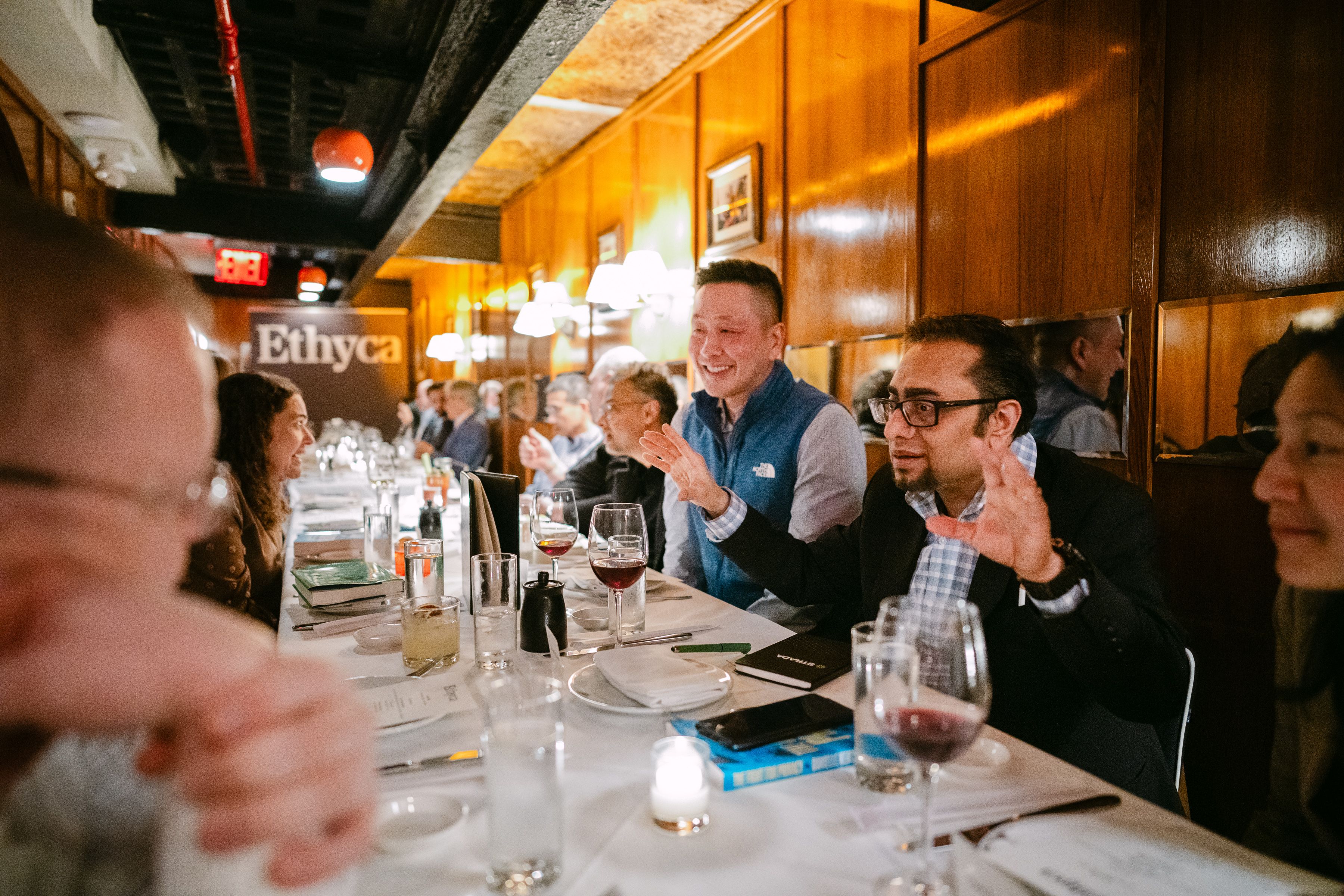 A busy dinner table with people talking.