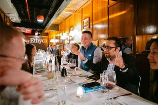 A busy dinner table with people talking.