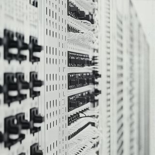 Monochromatic close-up of a circuit board with intricate pathways and components, showcasing the precision of electronic design