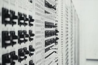 Monochromatic close-up of a circuit board with intricate pathways and components, showcasing the precision of electronic design