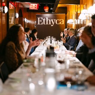 People sitting around a table in front of an Ethyca banner.