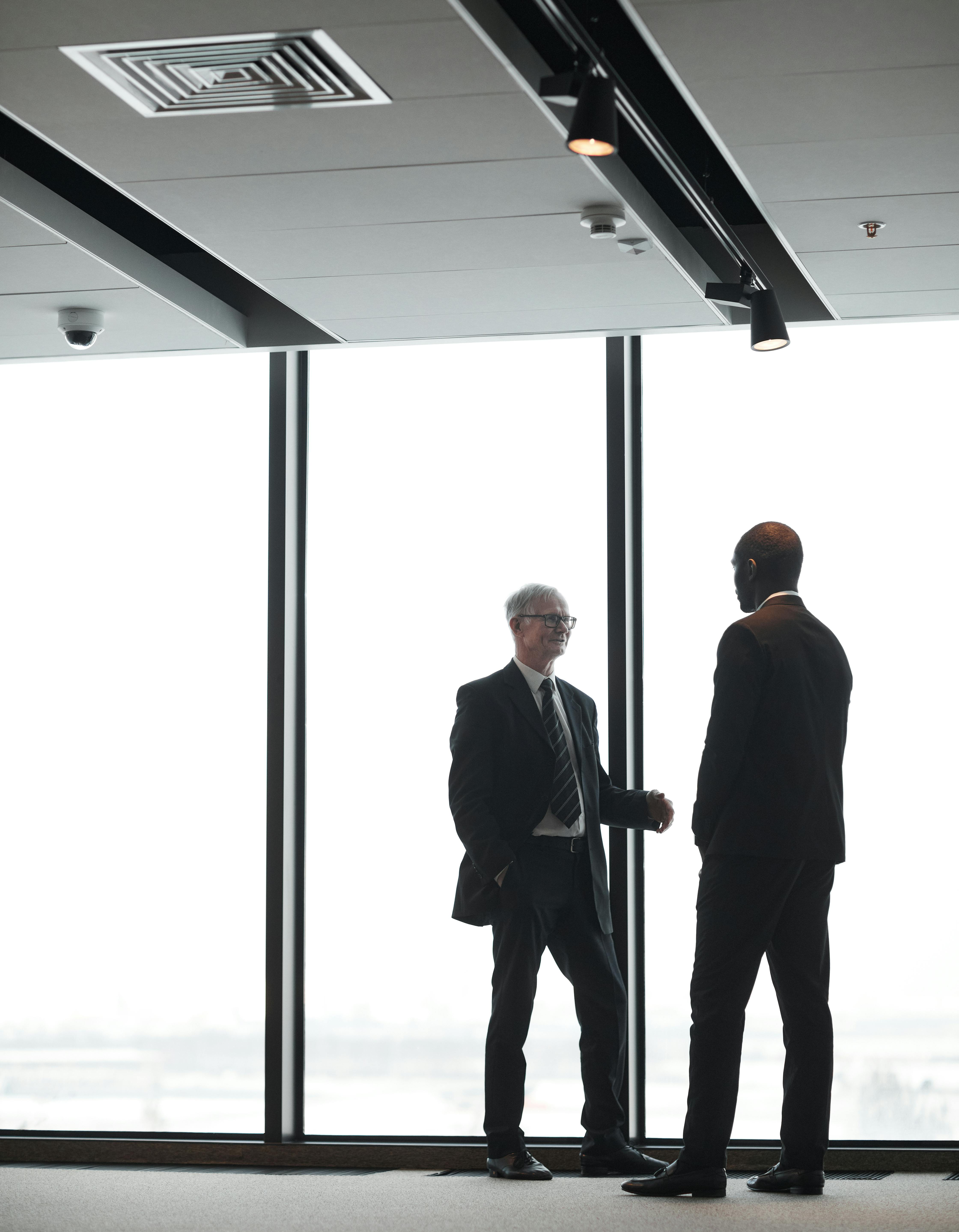 men-wearing-corporate-attire-having-a-conversation