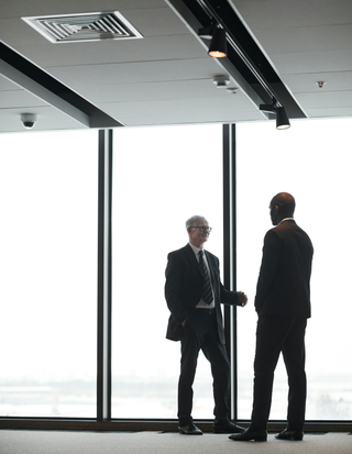 men-wearing-corporate-attire-having-a-conversation