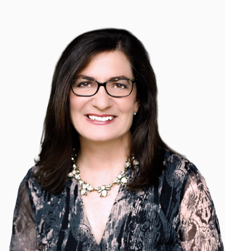 New Ethyca board member, Julie Brill, in a portrait shot in front of a grey background.