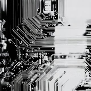 Monochromatic close-up of a circuit board with intricate pathways and components, showcasing the precision of electronic design