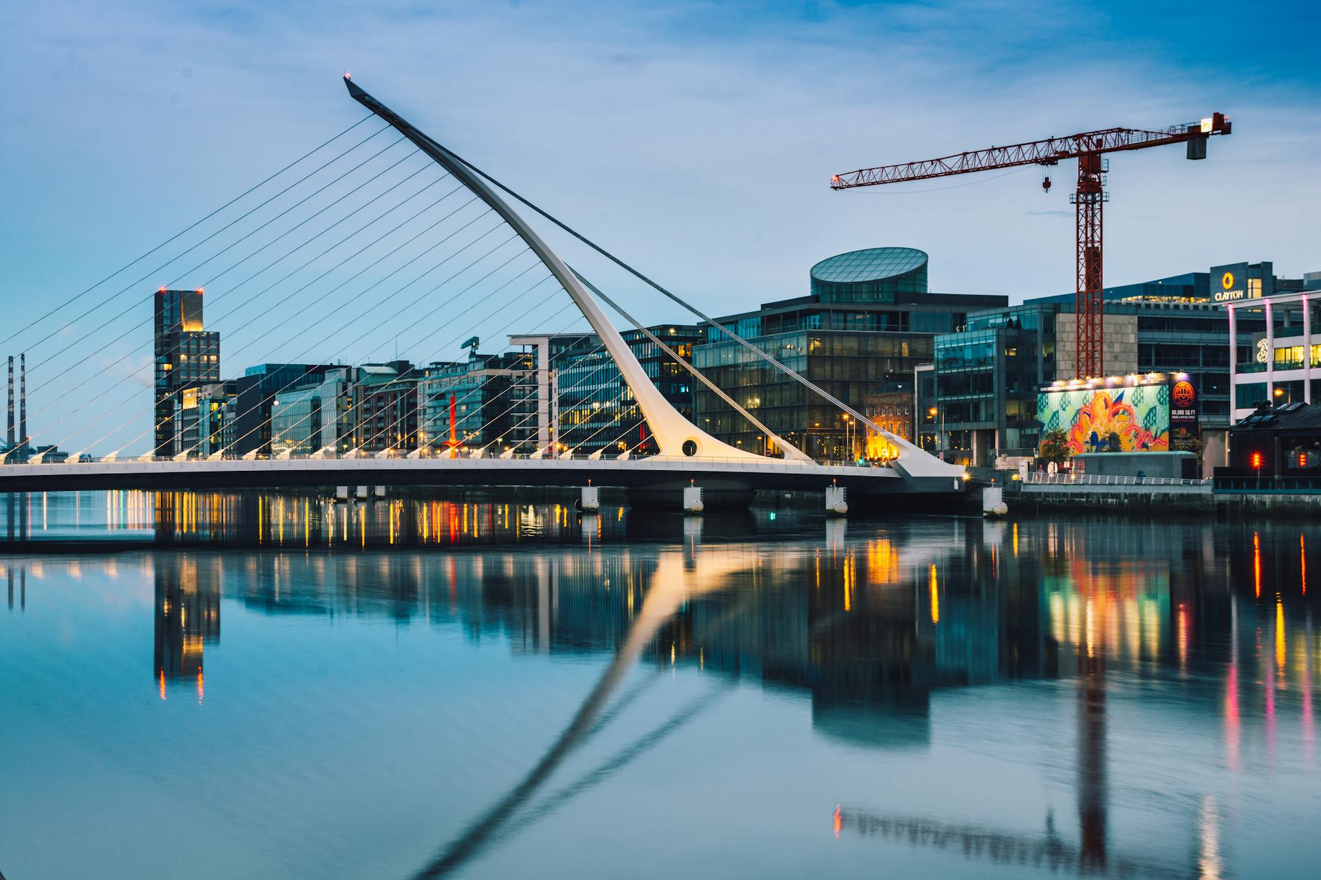Skyline of Dublin with a bridge, buildings and a crane.