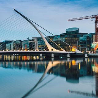 Skyline of Dublin with a bridge, buildings and a crane.