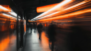 Blurred subway platform with orange train lights