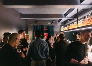 A busy bar with people talking.